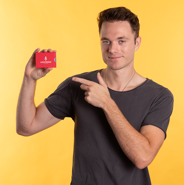 Man pointing at Lightspeed coffee product on a yellow background